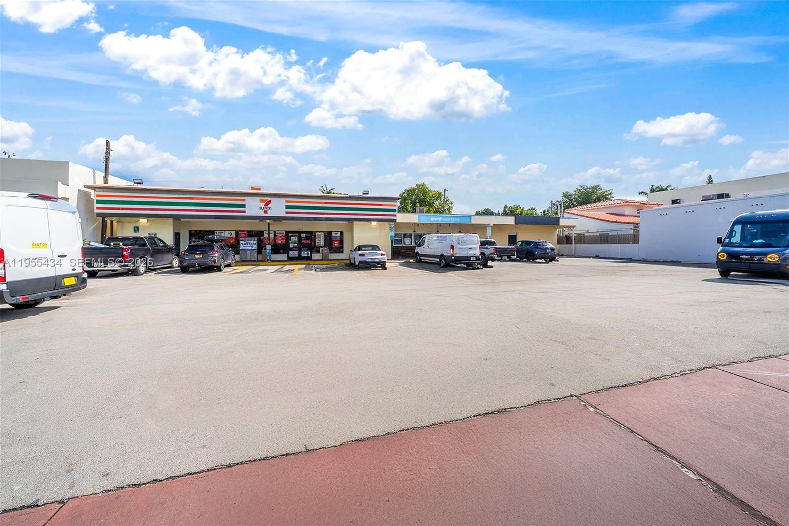 A 7-Eleven store with a large parking lot under a blue sky — 1441 Alton Rd, Miami Beach FL 33139, MIAMI BEACH, FL