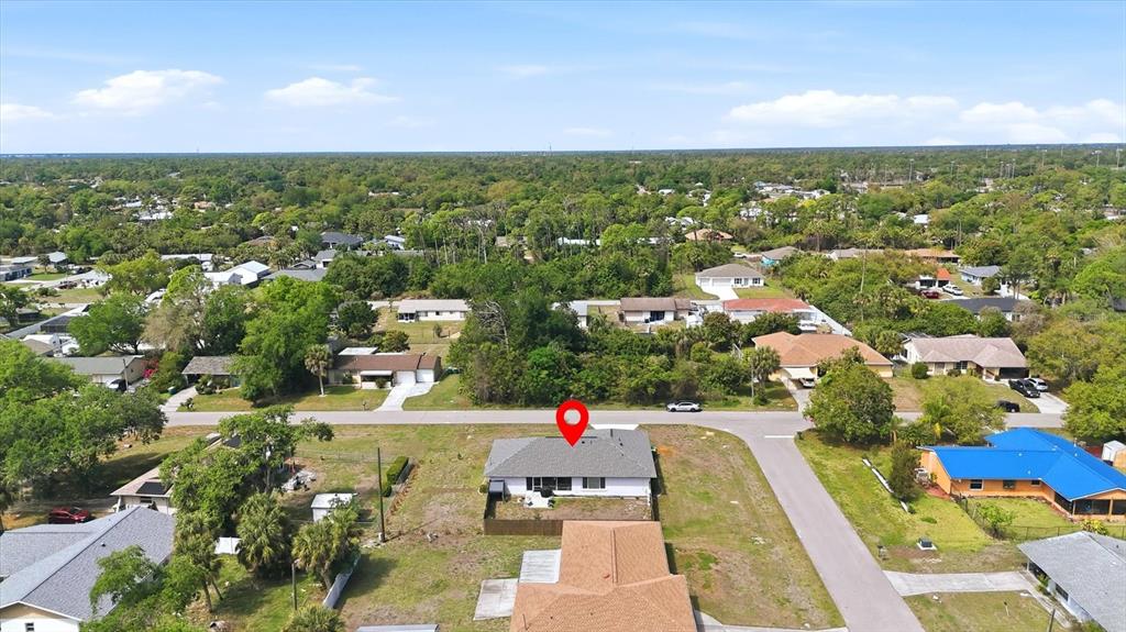 An aerial view shows a single-story house with a gray roof and a red pin — 2084 LEISURE STREET, PORT CHARLOTTE, FL