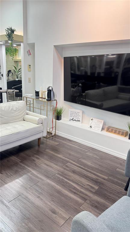 A waiting area features a white sofa, a gold console table, and a wall-mounted television — 13871 W HILLSBOROUGH AVENUE, TAMPA, FL