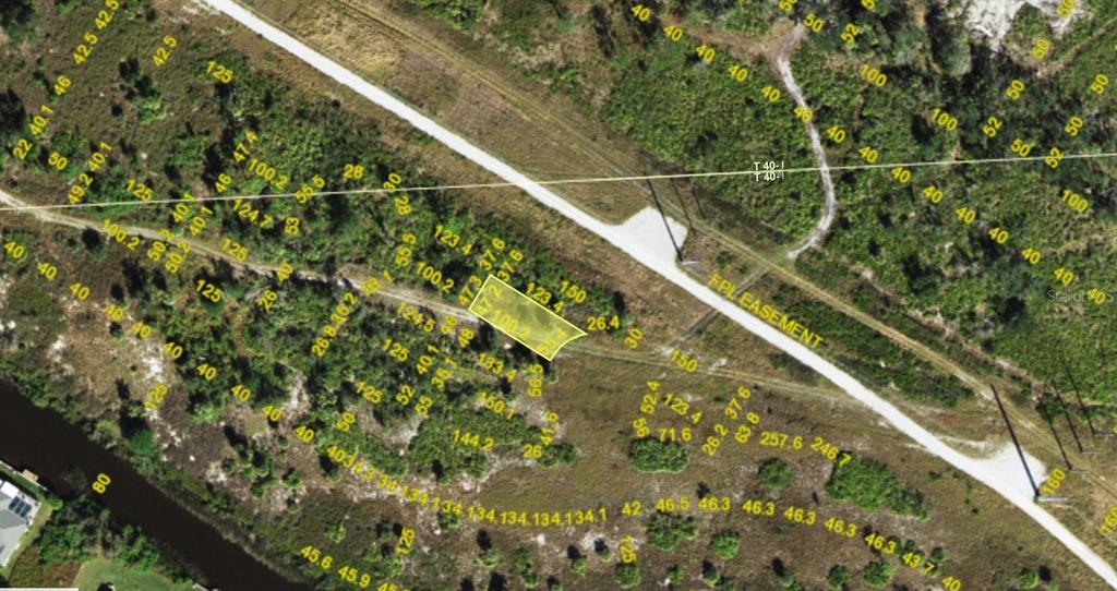 This is an aerial map showing a highlighted parcel of land near an FPL easement — 1547 BELASCO COURT, PUNTA GORDA, FL