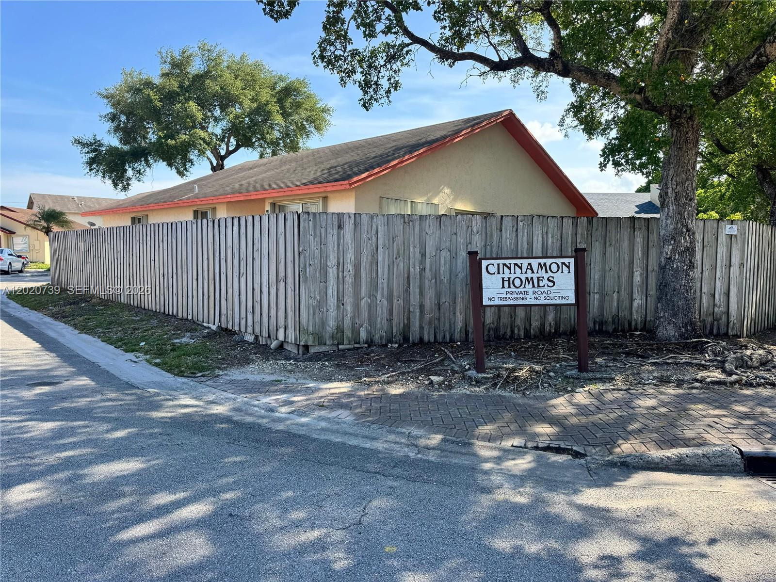 A wooden fence surrounds a house with a red roof near a private road sign — 2330 SW 80th Ter, Miramar FL 33025, MIRAMAR, FL