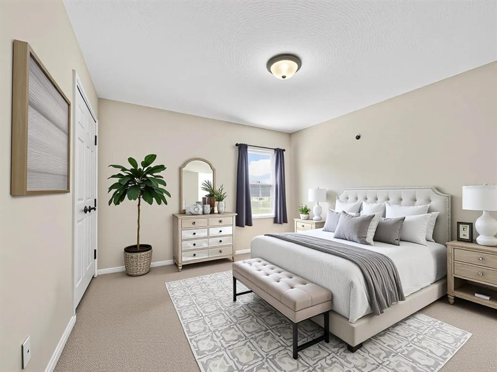 A bedroom features a tufted headboard, a mirrored dresser, and a bench on a patterned rug — 10411 PARK COMMONS DRIVE, ORLANDO, FL