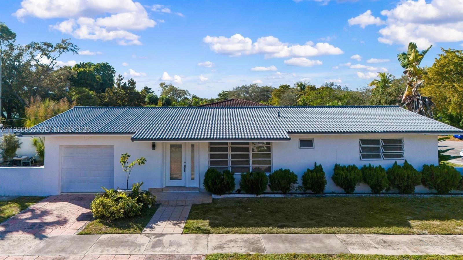A single-story white house with a gray tiled roof and a one-car garage — 8850 NE 4th Ave, El Portal FL 33138, EL PORTAL, FL