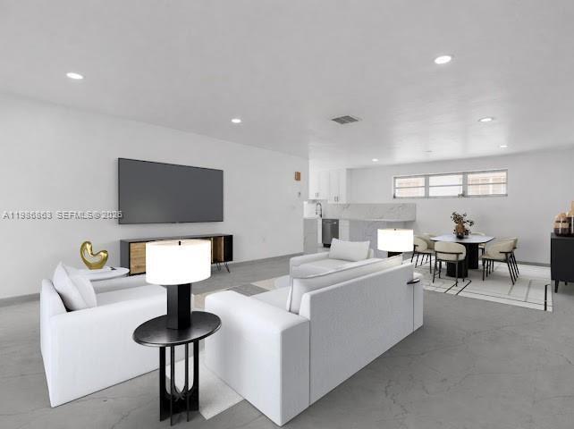 This is a digitally staged living and dining room with white walls and gray flooring — 8850 NE 4th Ave, El Portal FL 33138, EL PORTAL, FL