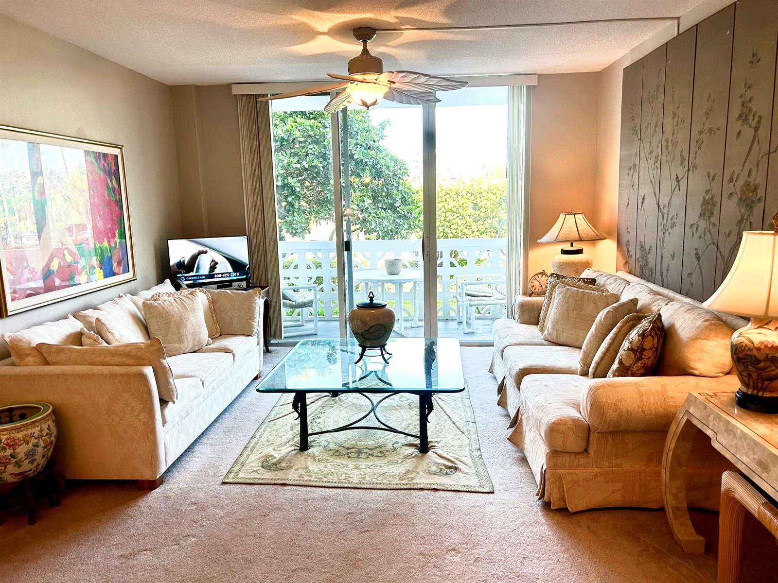 A living room features two beige sofas, a glass coffee table, and a balcony view — 2840 S Ocean Boulevard # 2210, Palm Beach FL 33480, PALM BEACH, FL