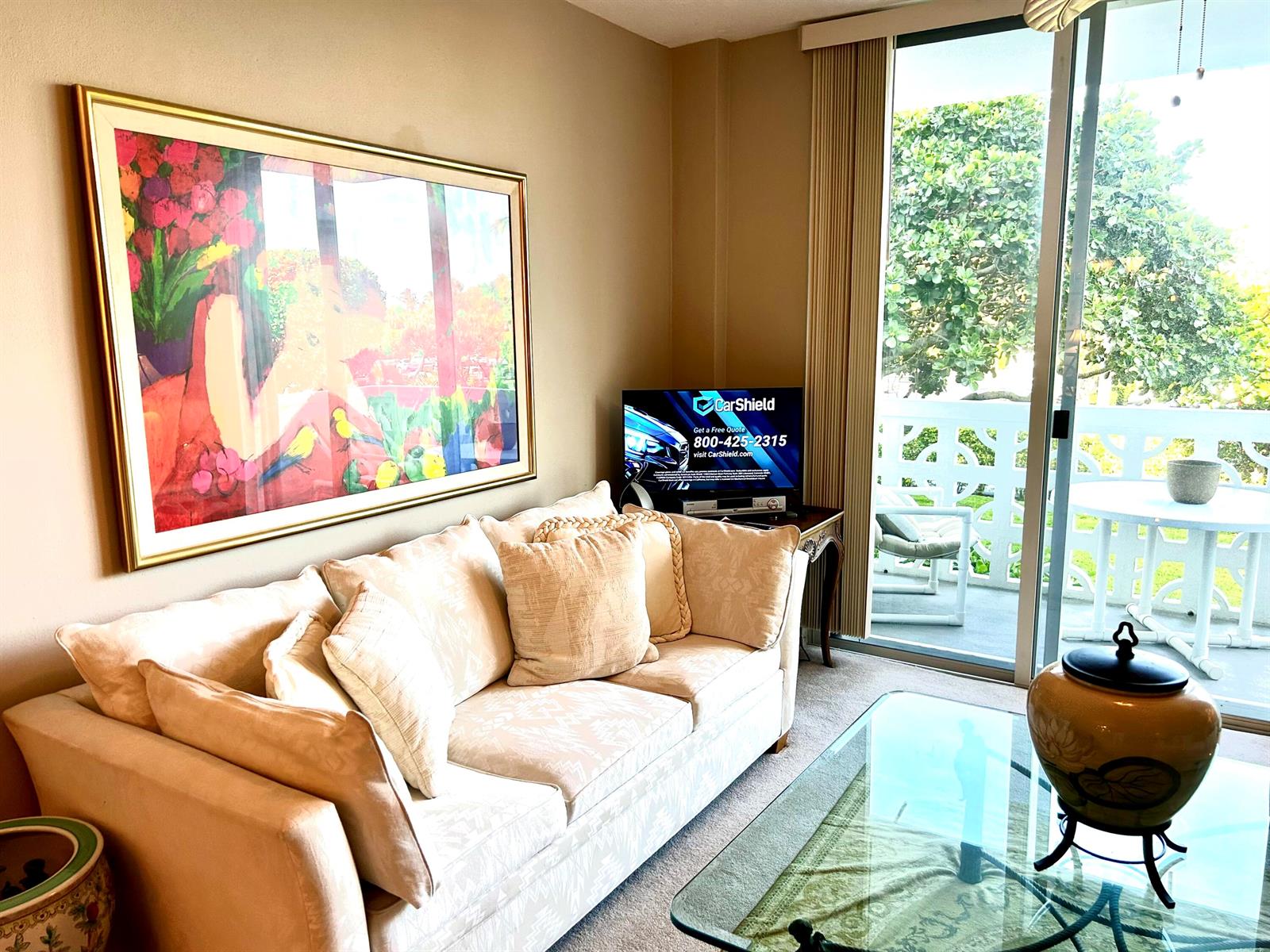 A living room features a beige sofa, large abstract art, and a glass-topped coffee table — 2840 S Ocean Boulevard # 2210, Palm Beach FL 33480, PALM BEACH, FL