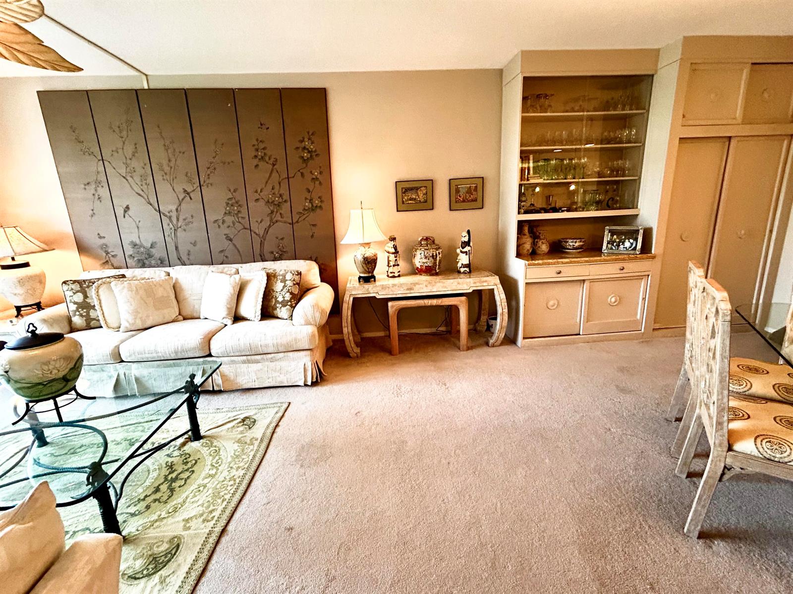 A living room features a beige sofa, a glass coffee table, and a built-in cabinet — 2840 S Ocean Boulevard # 2210, Palm Beach FL 33480, PALM BEACH, FL