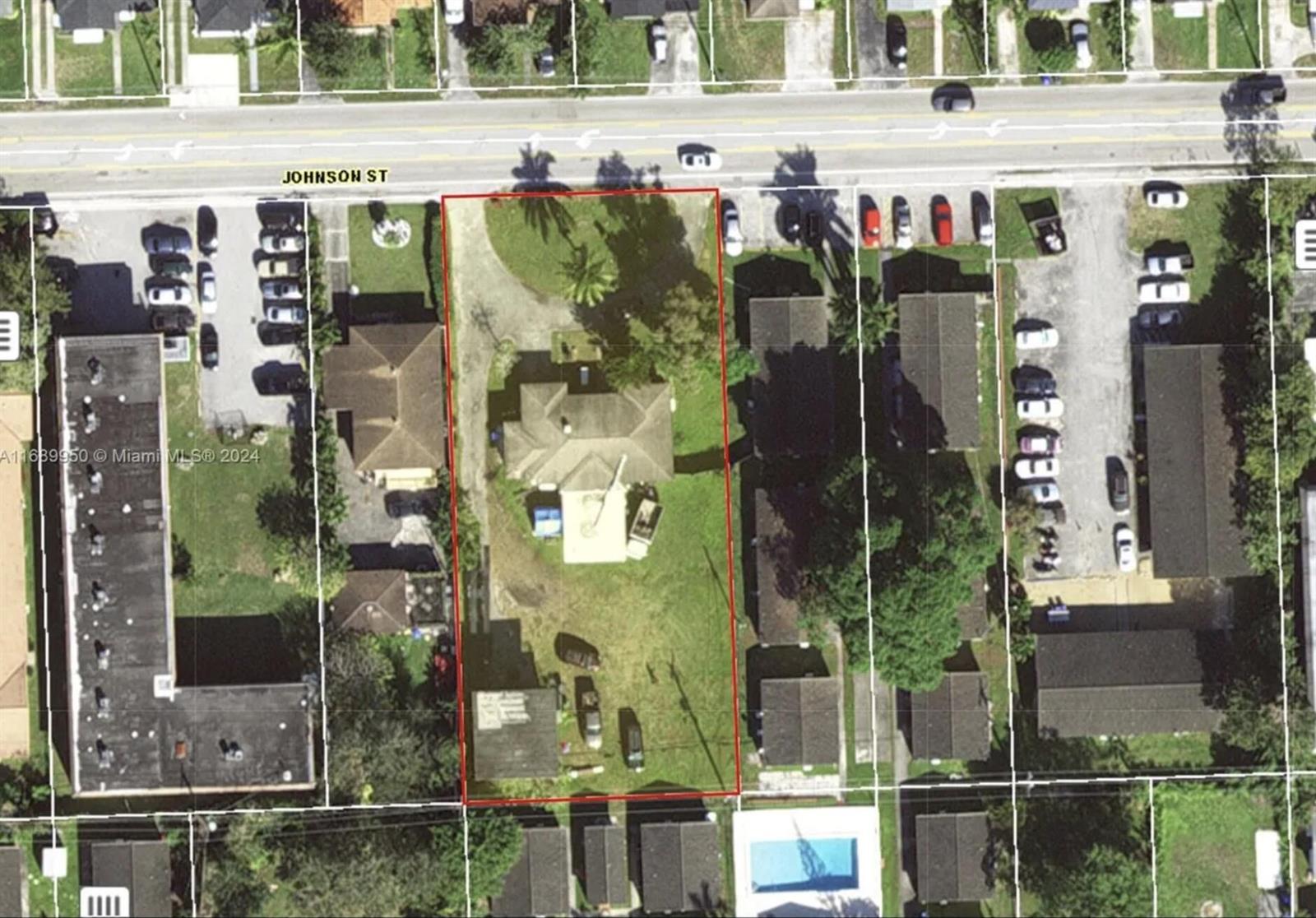 This aerial view shows a residential lot with a house, driveway, and detached structure — 2646 Johnson Street, Hollywood FL 33020, HOLLYWOOD, FL