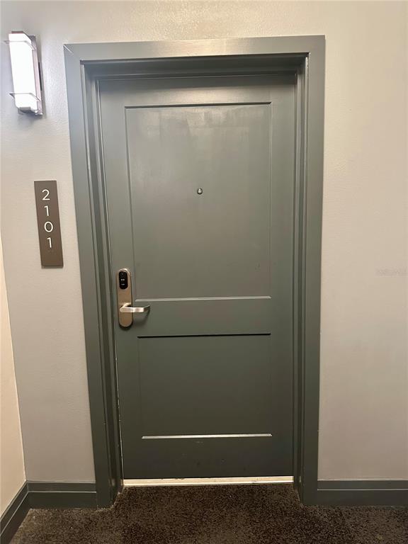 A gray door with a digital lock and the number 2101 mounted on the wall — 14501 GROVE RESORT AVENUE UNIT 2101, WINTER GARDEN, FL