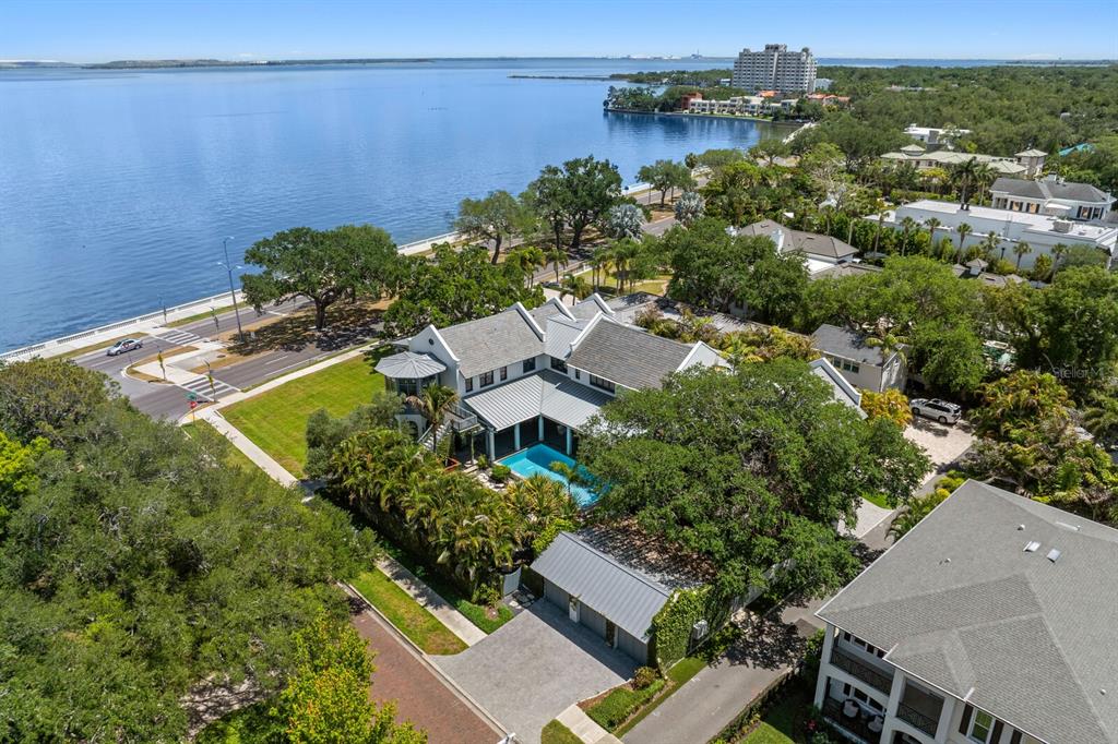 An aerial view shows a large waterfront house with a swimming pool and metal roof — 4613 BAYSHORE BOULEVARD, TAMPA, FL