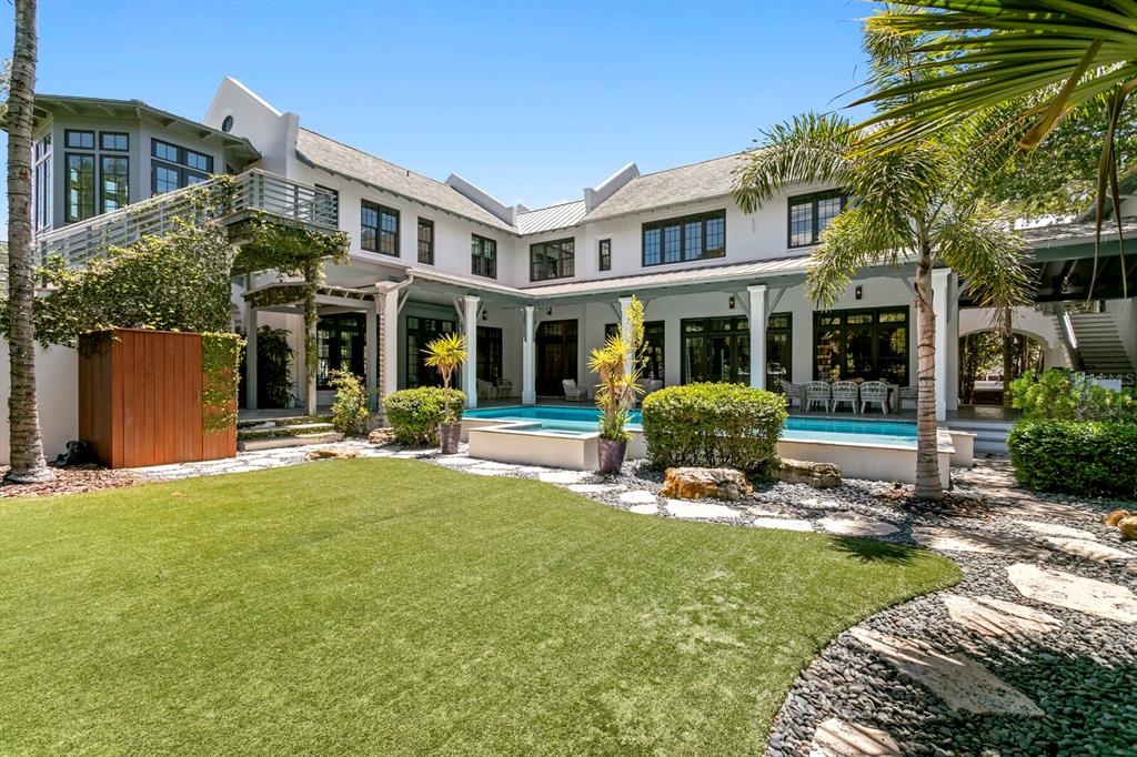 A two-story white house features a swimming pool, a grassy lawn, and a wooden shed — 4613 BAYSHORE BOULEVARD, TAMPA, FL