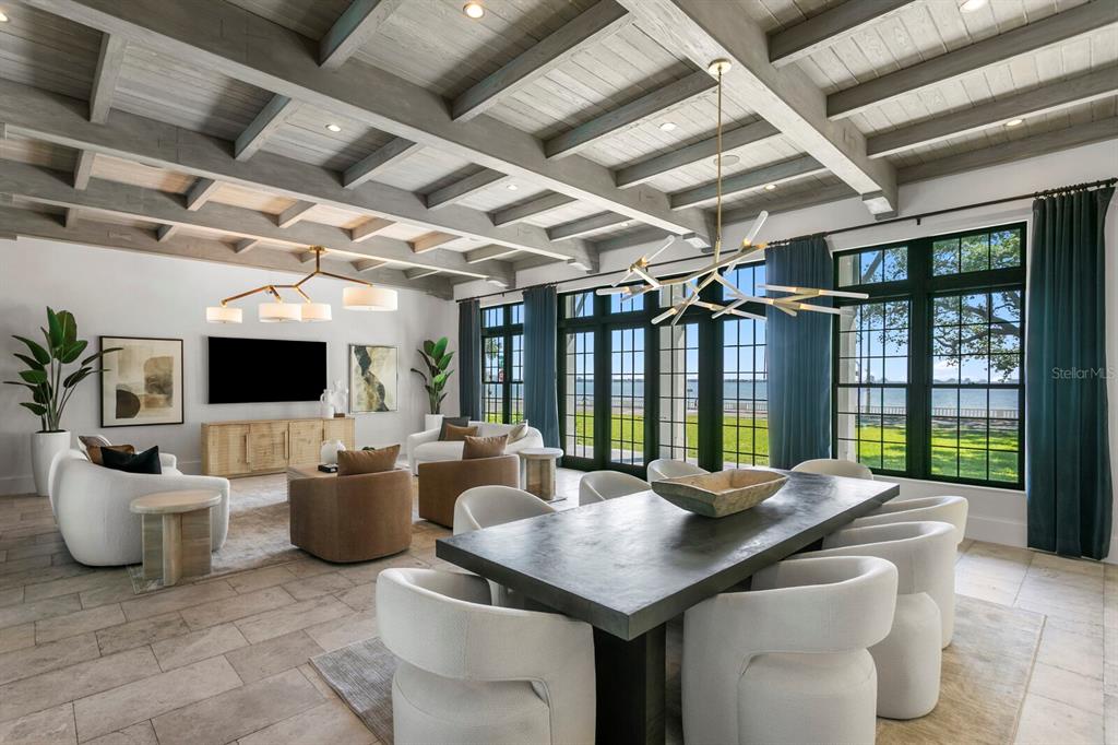 An open-concept living and dining room features a coffered wood ceiling and large window walls — 4613 BAYSHORE BOULEVARD, TAMPA, FL