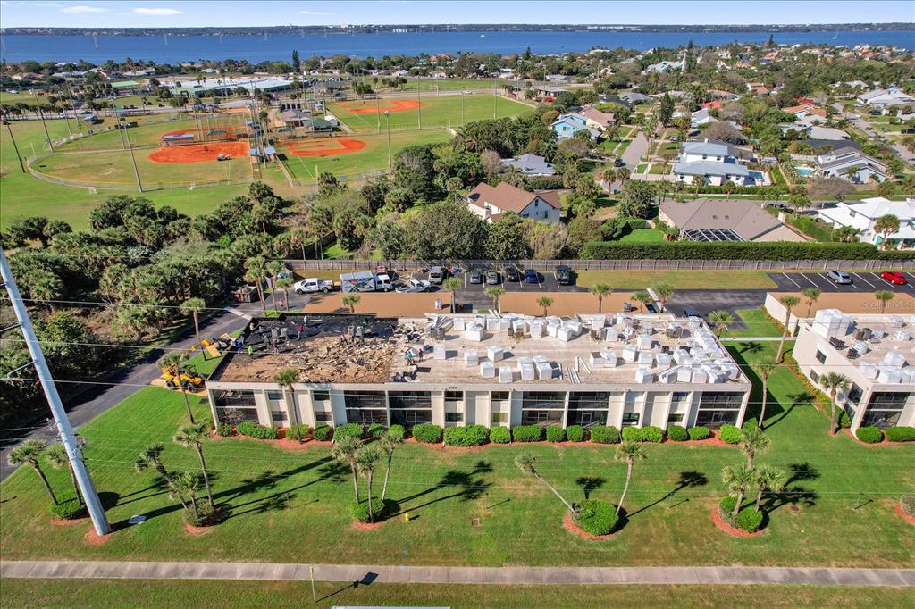 An aerial view shows a commercial building with a partially replaced flat roof — 2150 ATLANTIC STREET UNIT 413, MELBOURNE BEACH, FL