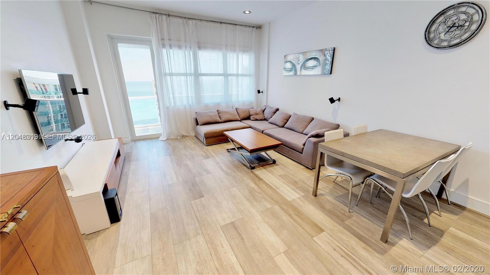 A living room features a sectional sofa, dining table, and a balcony with ocean views — 3725 S Ocean Dr, Hollywood FL 33019, HOLLYWOOD, FL