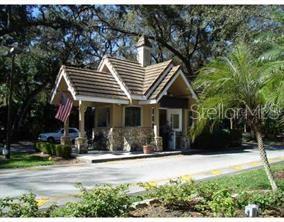 A white exterior door features a rectangular glass window with a decorative grid pattern — 123 TOMOKA TRAIL UNIT 123, LONGWOOD, FL