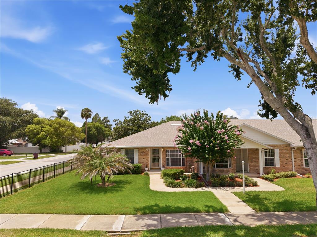 A single-story brick house with a front lawn, sidewalk, and a large tree — 914 MICHIGAN AVENUE, ST CLOUD, FL