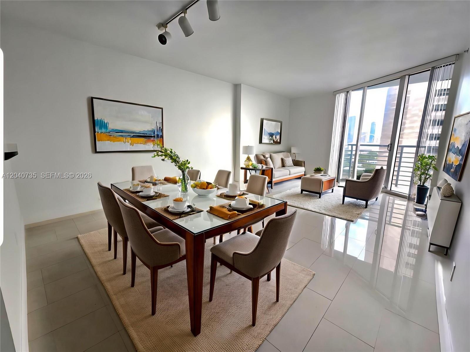 A dining area with a glass table and chairs opens into a living room — 335 S Biscayne Blvd # 2202, Miami FL 33131, MIAMI, FL