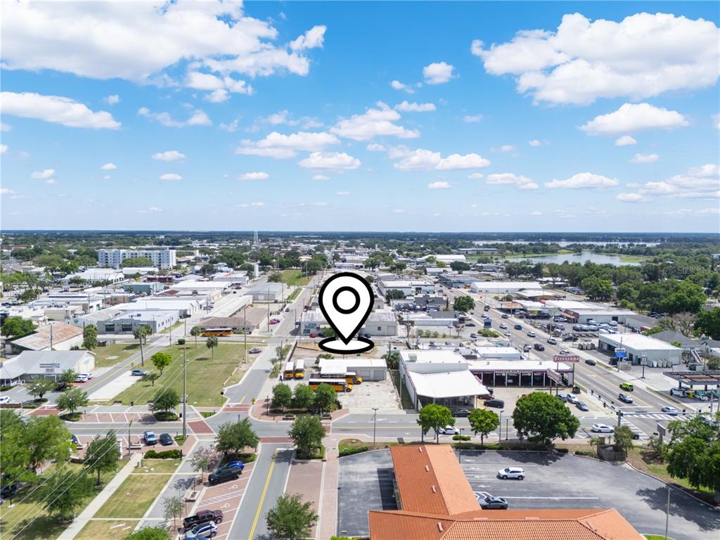 An aerial view shows a commercial area with a map pin marking a vacant lot — 165 5TH STREET SW, WINTER HAVEN, FL