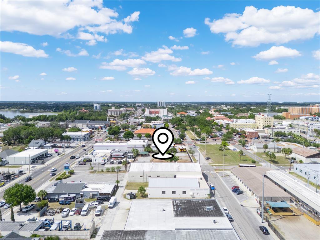 An aerial view shows a commercial building with a location pin in a city — 165 5TH STREET SW, WINTER HAVEN, FL