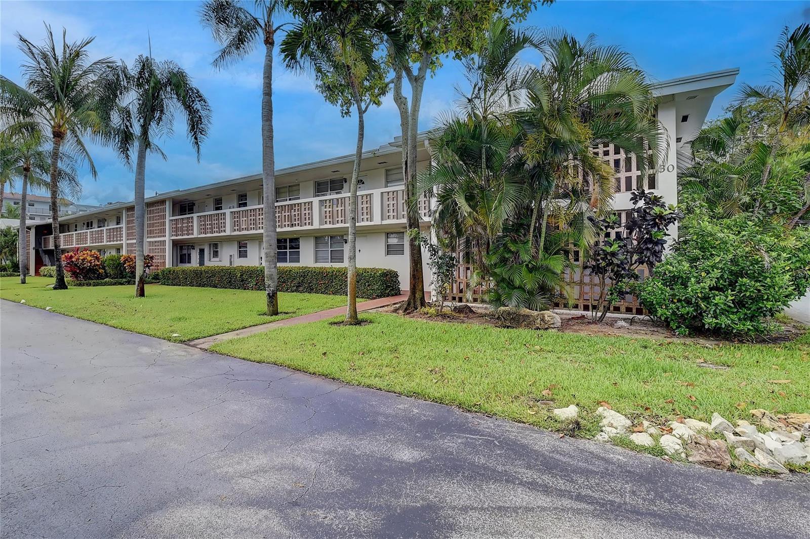 A two-story apartment building with a walkway, palm trees, and landscaping in front — 30 SE 13th Street # B2, Boca Raton FL 33432, BOCA RATON, FL