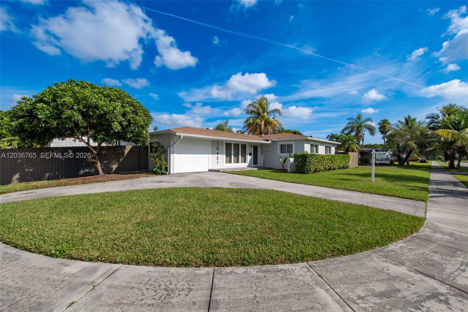 A single-story house with a circular driveway, a green lawn, and palm trees — 10431 SW 93rd St, Miami FL 33176, MIAMI, FL
