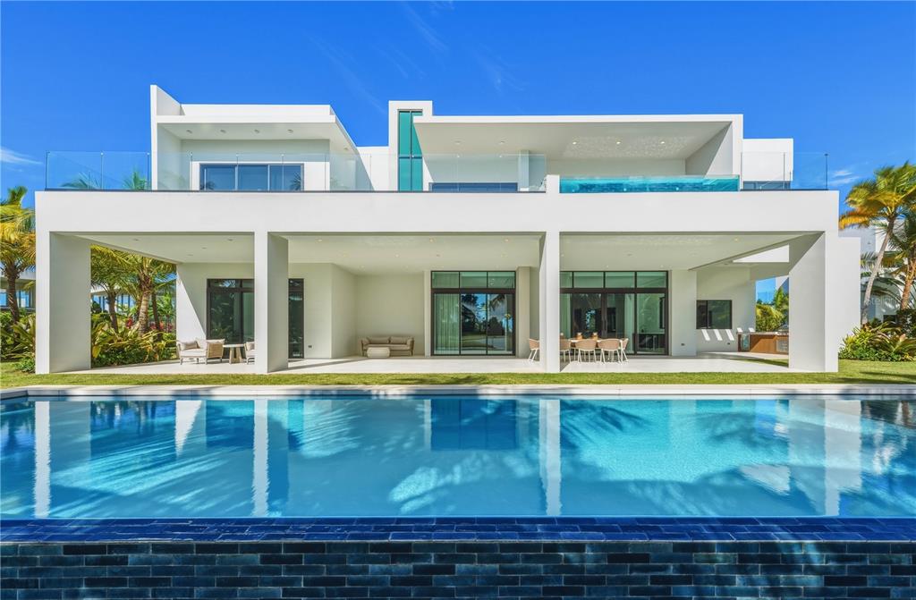 A modern white two-story house with a swimming pool and a second-floor glass-walled pool — G8 ATLANTIC DRIVE, 7000 BAHIA BEACH BLVD., RIO GRANDE, PR
