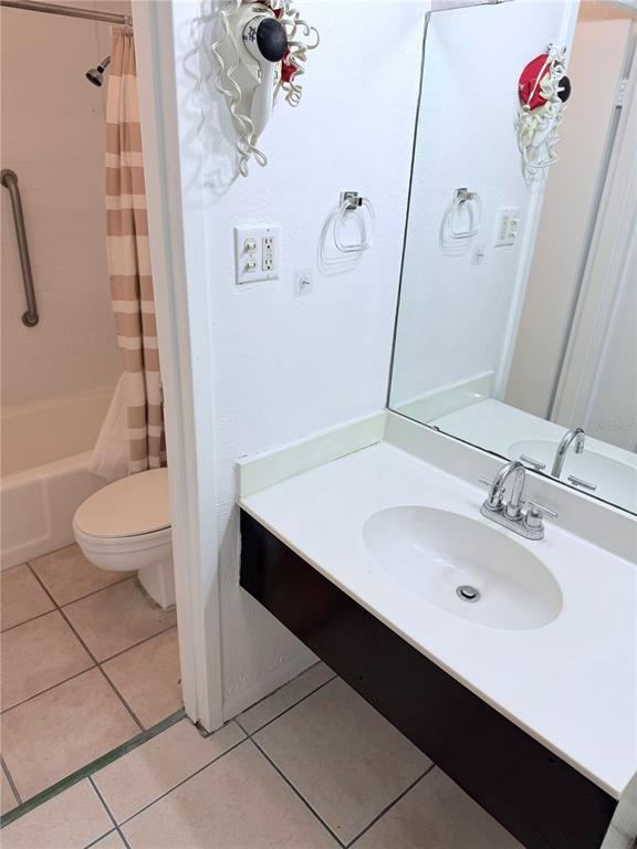 A bathroom features a white vanity with a sink, a mirror, and a separate toilet area — 43420 HIGHWAY 27 UNIT 436, DAVENPORT, FL