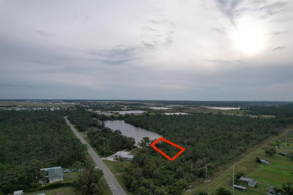 An aerial view shows a rectangular plot of land outlined in red near a lake — 4515 S FAIRWAY DRIVE, PUNTA GORDA, FL