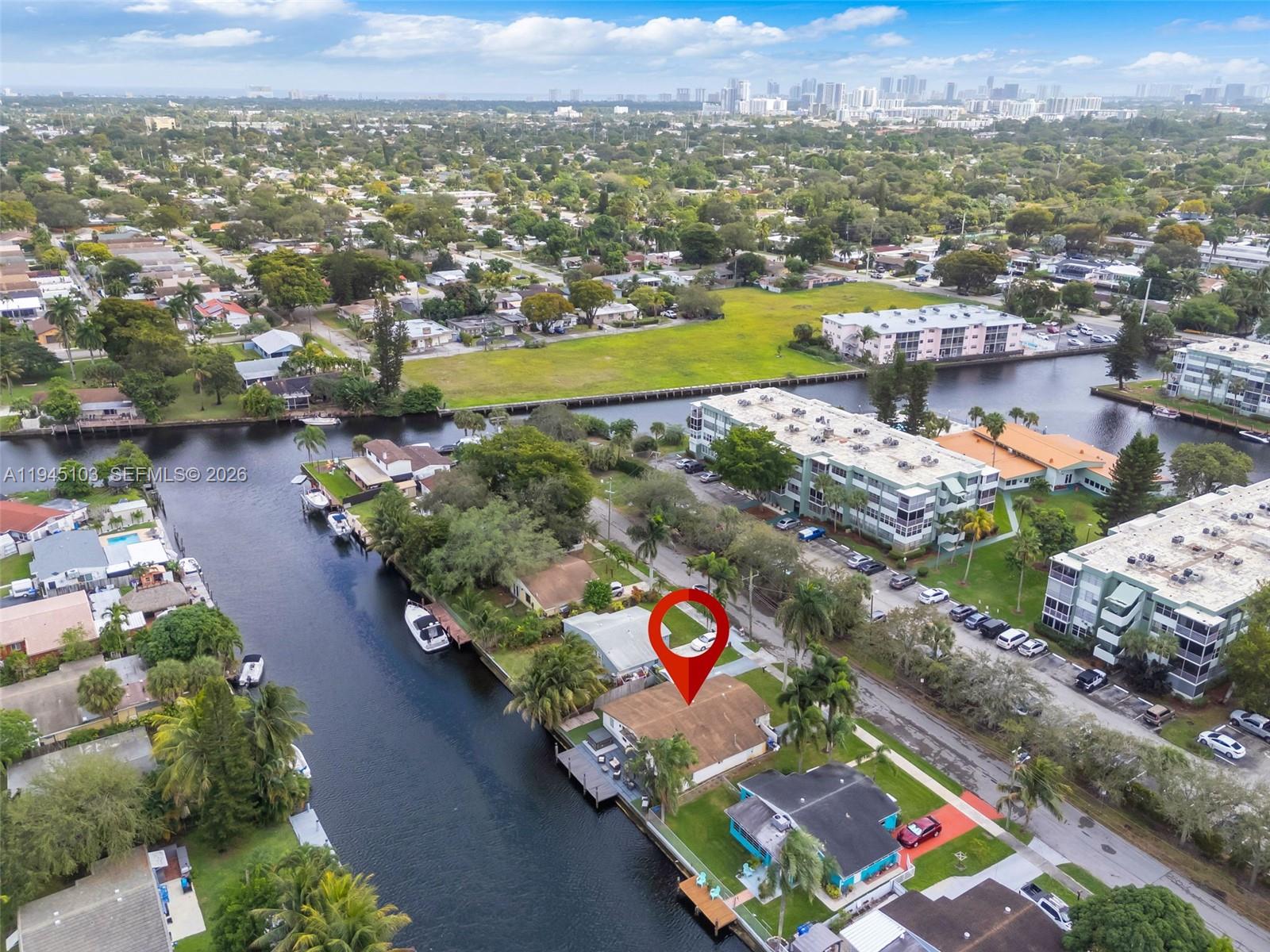 An aerial view shows a waterfront house with a dock and a red location pin — 2721 Harding St, Hollywood FL 33020, HOLLYWOOD, FL