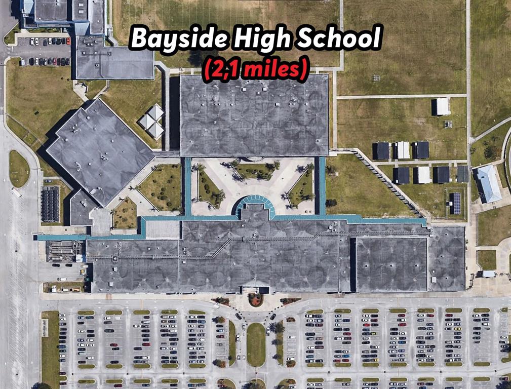 This aerial view shows the school building and parking lot of Bayside High School — 342 DADEVILLE STREET SE, PALM BAY, FL