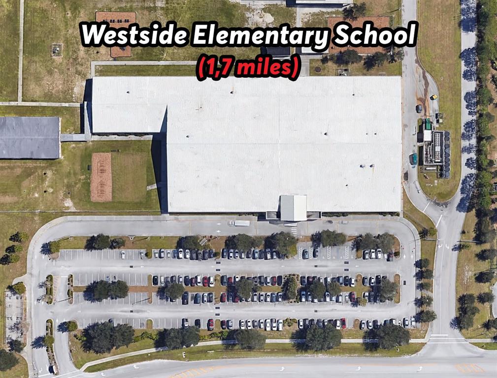 This is an aerial view of a school building with a large parking lot — 342 DADEVILLE STREET SE, PALM BAY, FL