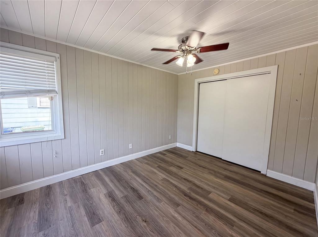 A kitchen and dining area feature white cabinets, a central island, and wood-look flooring — 1521 W RIVER SHORE WAY, TAMPA, FL