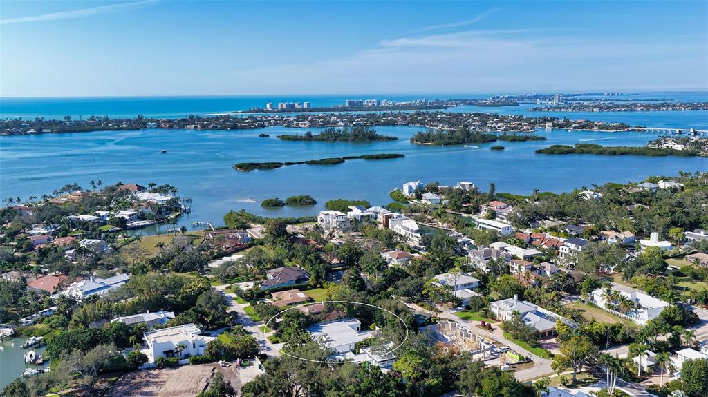 An aerial view shows a residential property circled in white amidst a coastal neighborhood — 1421 N LAKE SHORE DRIVE, SARASOTA, FL