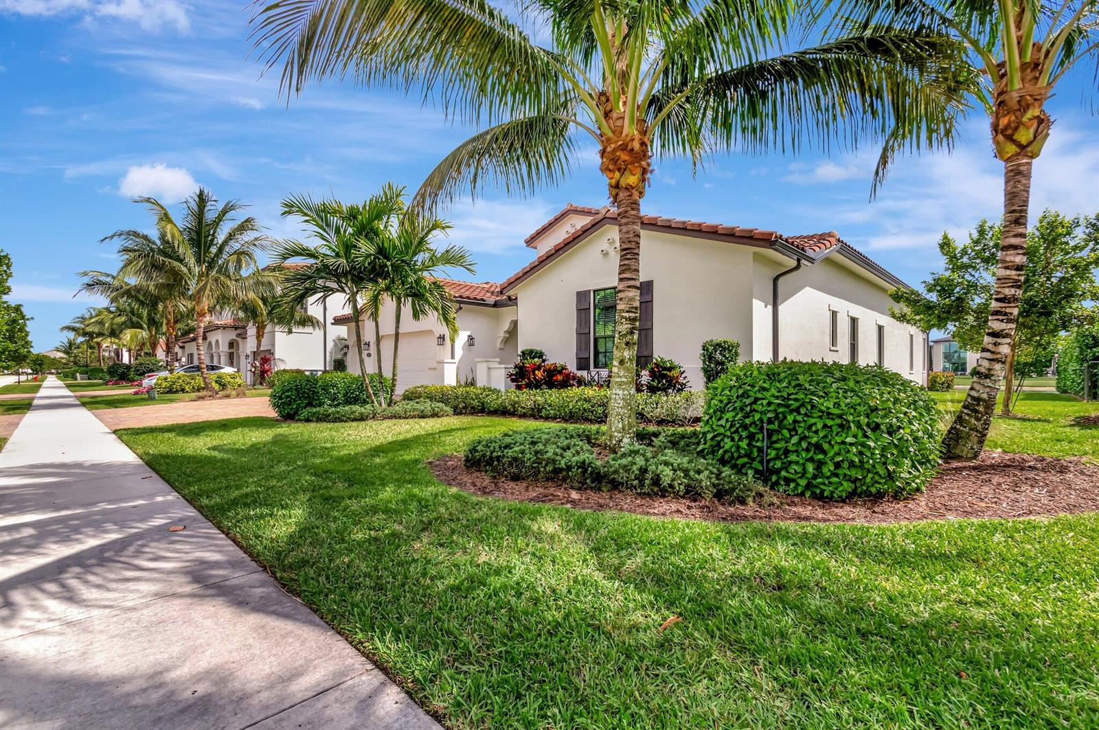 A single-story white house with a tile roof, palm trees, and a manicured front lawn — 8212 Grand Prix Lane, Boynton Beach FL 33472, BOYNTON BEACH, FL