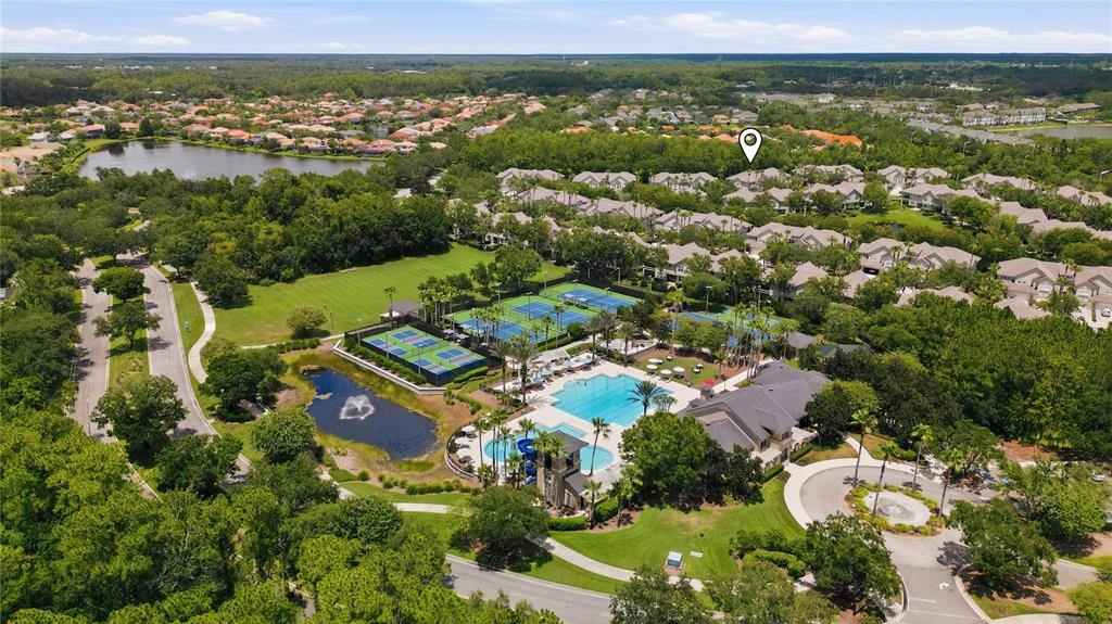 An aerial view shows a community clubhouse with a swimming pool, tennis courts, and pond — 14613 MIRABELLE VISTA CIRCLE, TAMPA, FL