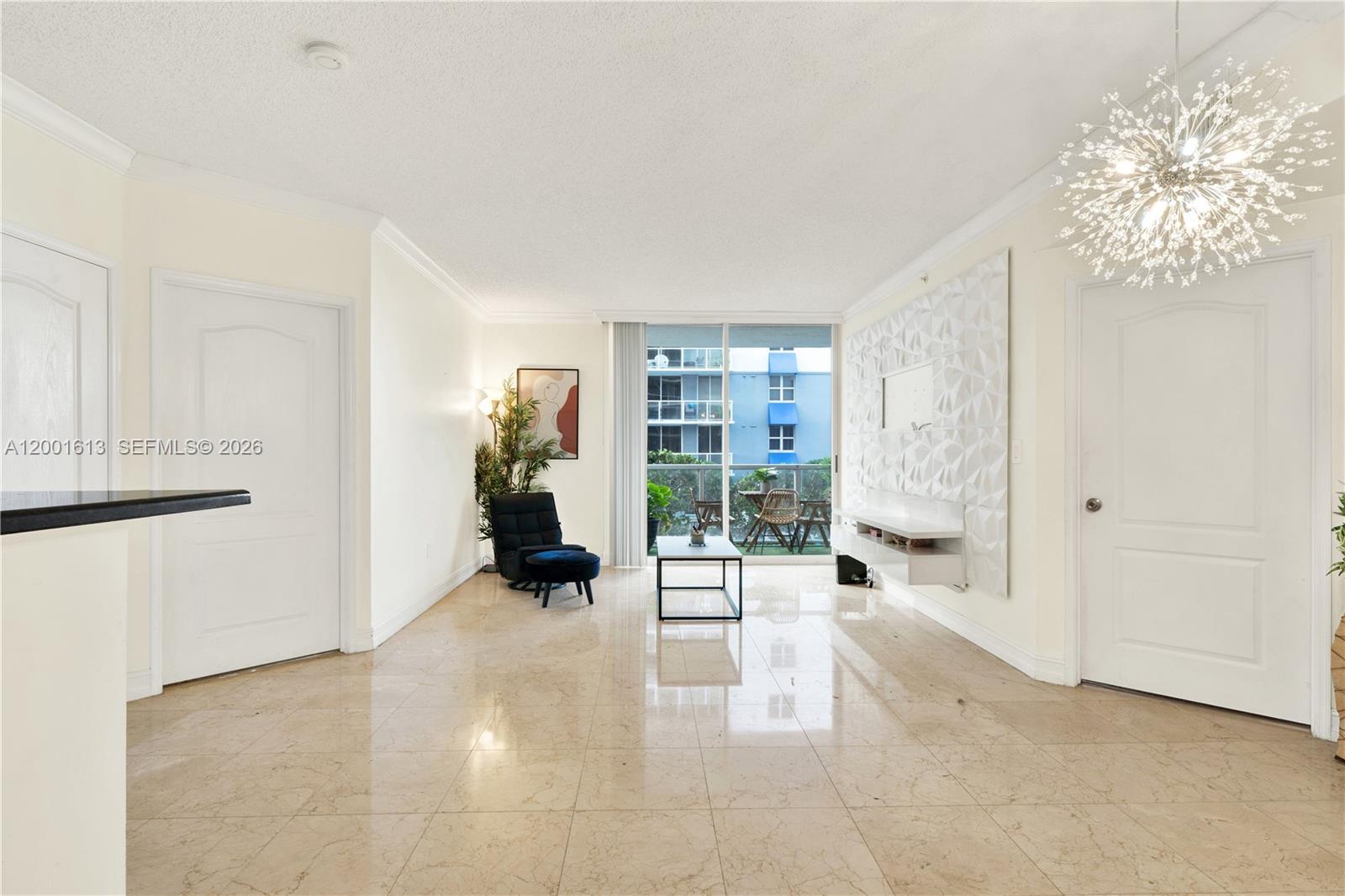 A living room features beige tile floors, a textured accent wall, and a balcony view — 5077 NW 7th St # 508, Miami FL 33126, MIAMI, FL