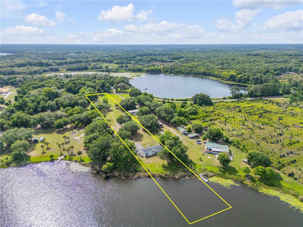 An aerial view shows a waterfront property outlined in yellow with a house and trees — 640 UNION AVENUE, CRESCENT CITY, FL