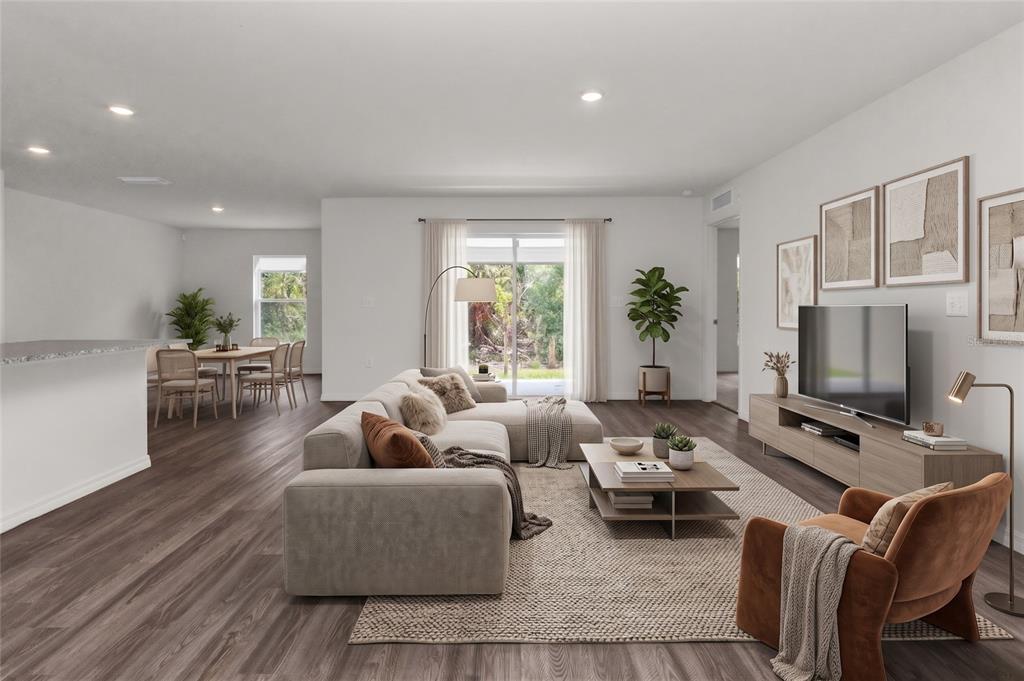 This digital rendering shows an open-concept living room with wood-look flooring and a dining area — 1040 SHERWIN STREET, PORT CHARLOTTE, FL