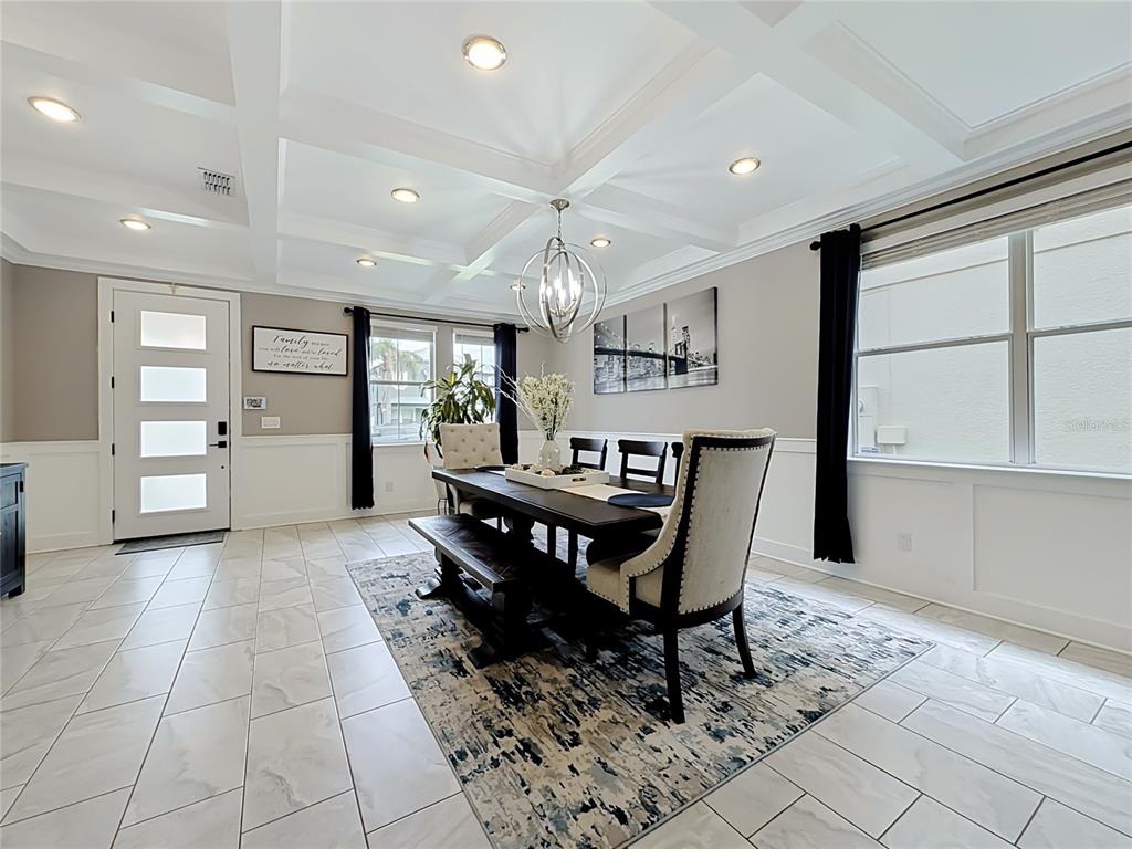 A dining room features a coffered ceiling, tile flooring, and a dark wood table set — 1515 BLUE HORIZON DRIVE, CLERMONT, FL