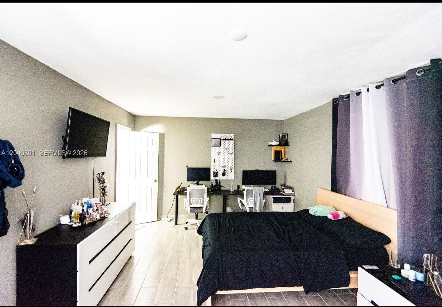 A kitchenette features white cabinets, a wood-look countertop, a backsplash, and a stainless sink — 359 W 12th St # 3, Hialeah FL 33010, HIALEAH, FL
