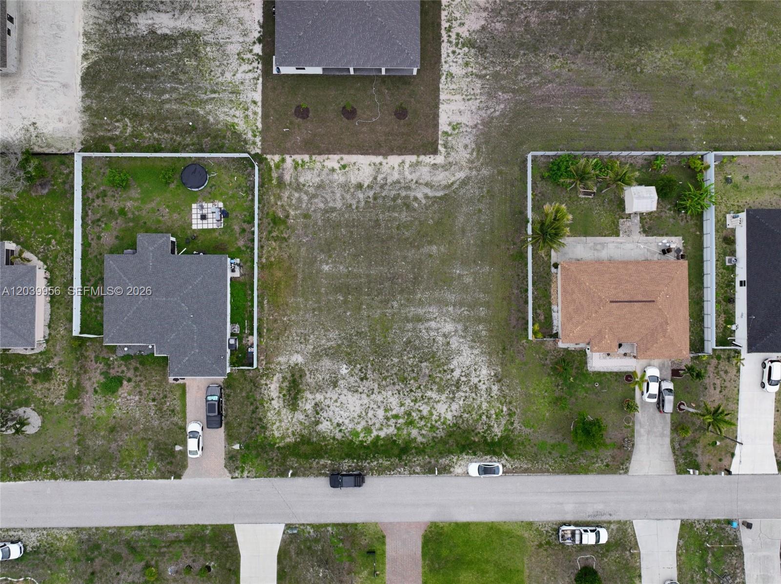 An aerial view shows a vacant residential lot situated between two existing houses — 530 NW 23RD TER, Cape Coral FL 33993, CAPE CORAL, FL