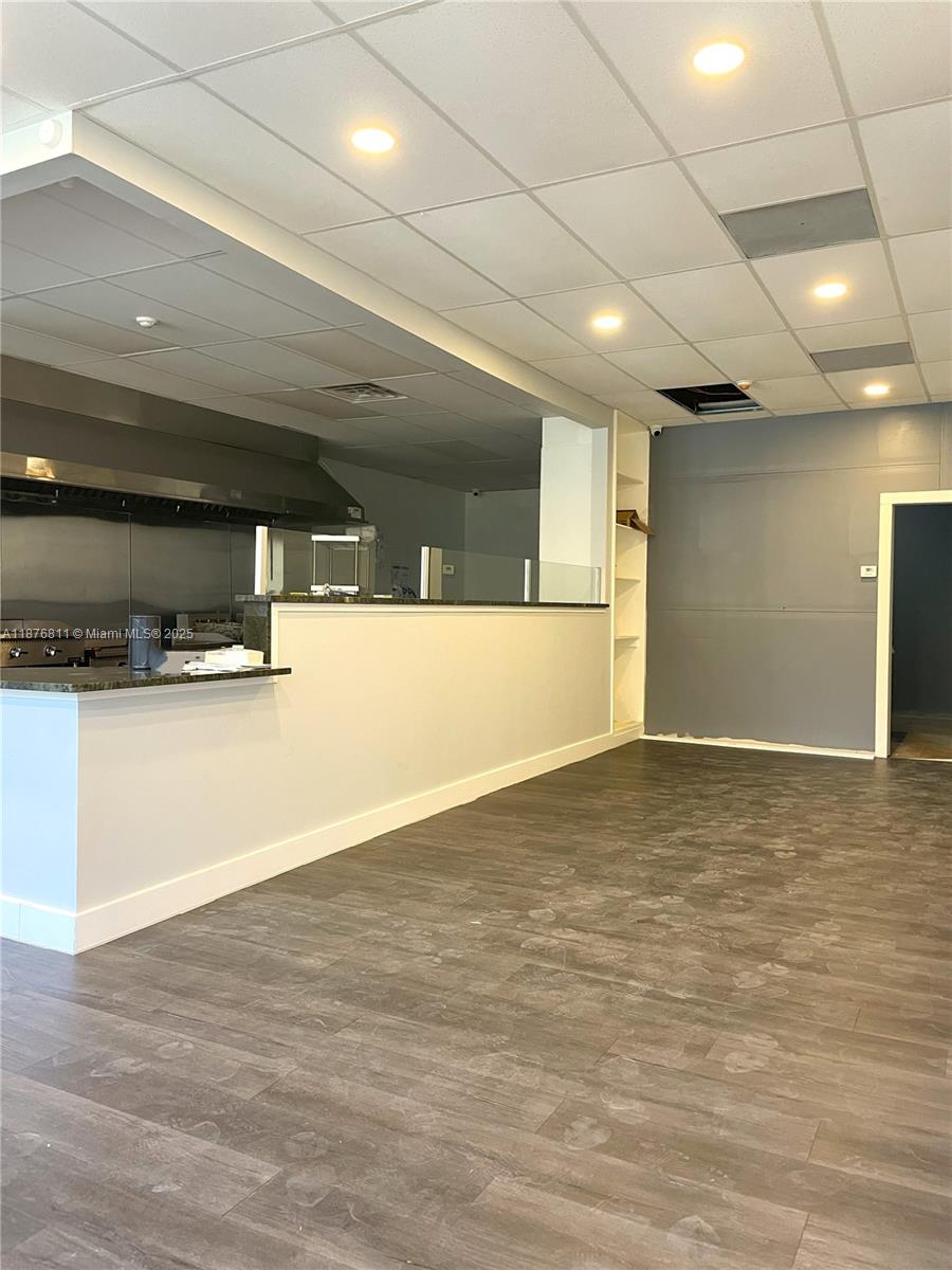 This commercial space features a service counter, a kitchen area, and wood-look flooring — 550 Piedmont Ave, GA 30308, GA