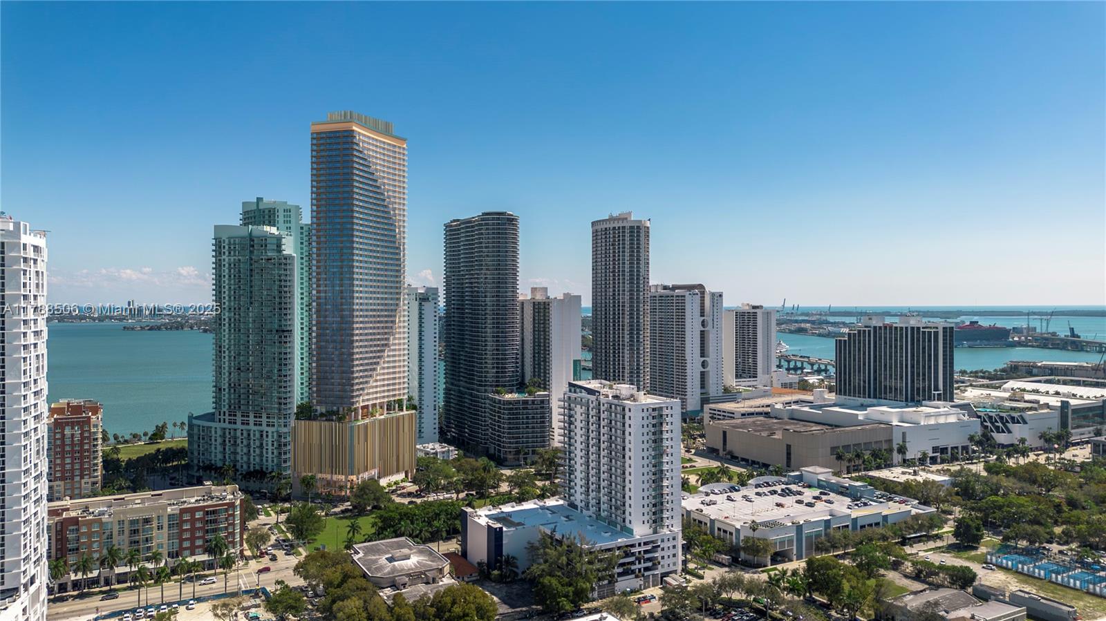 This exterior view shows a dense urban skyline with several high-rise residential towers near water — 1837 NE 4th Ave # 2004, Miami FL 33132, MIAMI, FL