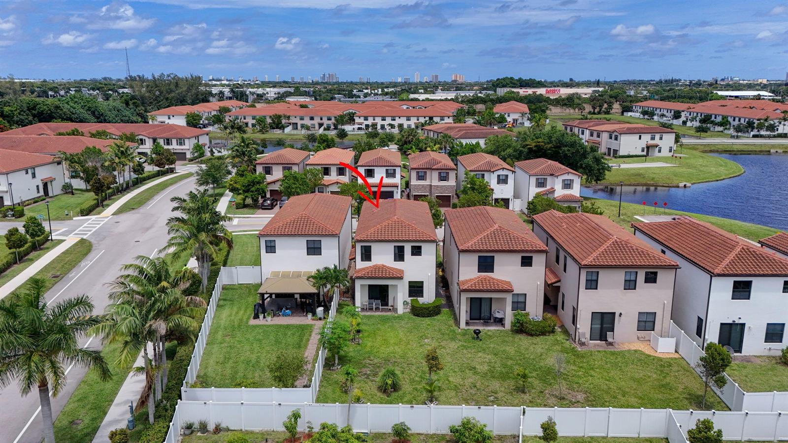 An aerial view shows a two-story residential house with a red tile roof and backyard — 4009 Sequoia Place, Riviera Beach FL 33410, RIVIERA BEACH, FL