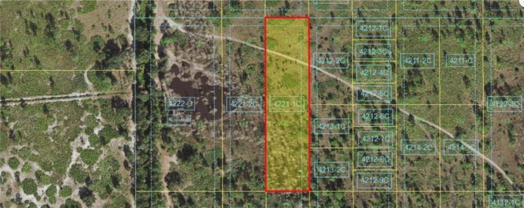 This is an aerial map showing a rectangular parcel of land highlighted in red — HOLOPAW GROVES ROAD, ST CLOUD, FL