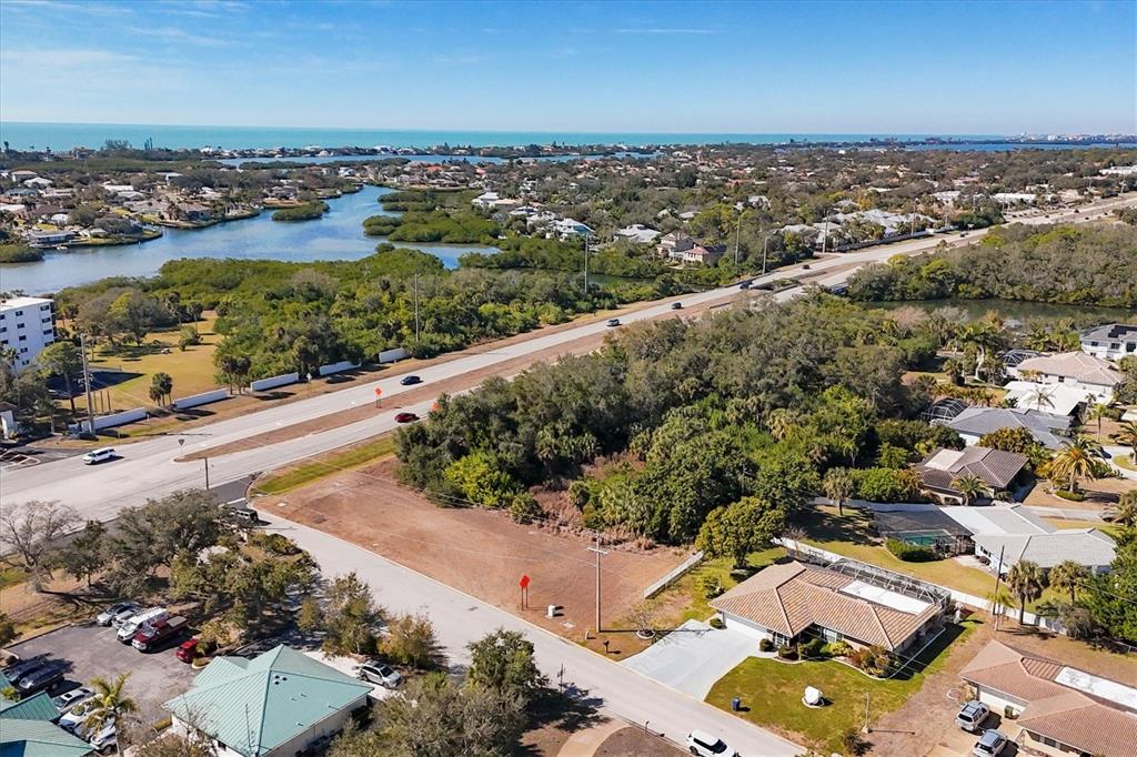 An aerial view shows a vacant lot situated between a residential street and a highway — 2099 S TAMIAMI TRAIL, OSPREY, FL
