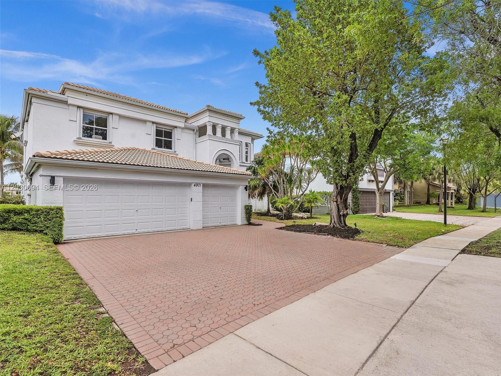 A two-story white house with a tiled roof and a brick paver driveway — 4971 SW 158th Ave, Miramar FL 33027, MIRAMAR, FL