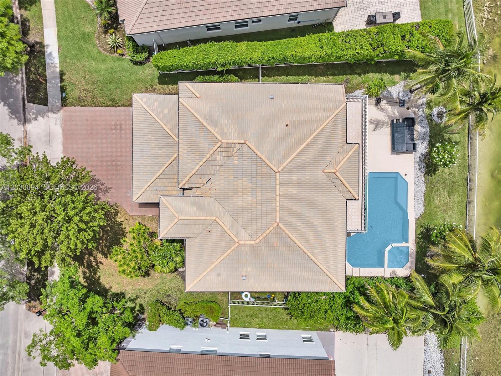 An aerial view shows a house with a tiled roof, a pool, and surrounding landscaping — 4971 SW 158th Ave, Miramar FL 33027, MIRAMAR, FL
