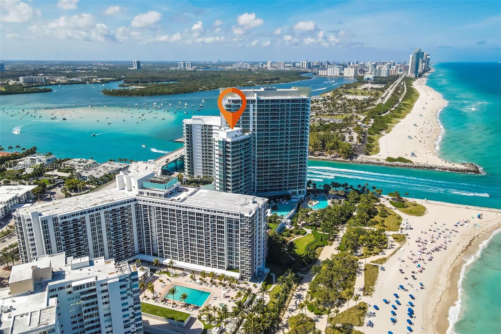 An aerial view of a high-rise condominium complex situated between the ocean and a bay — 10295 Collins Ave # 701, Bal Harbour FL 33154, BAL HARBOUR, FL