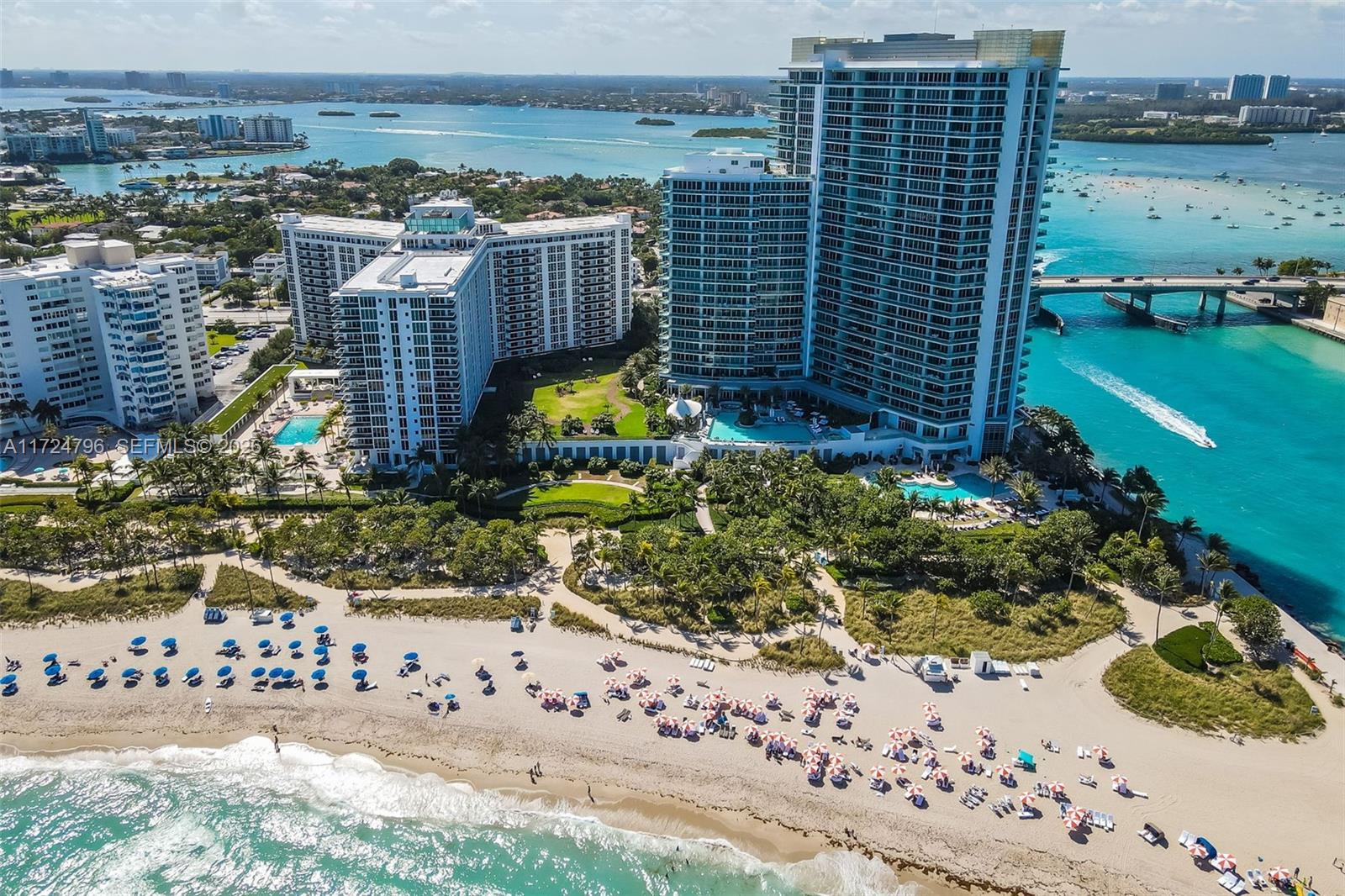 An aerial view shows high-rise residential buildings situated on a beach with a nearby bridge — 10295 Collins Ave # 701, Bal Harbour FL 33154, BAL HARBOUR, FL
